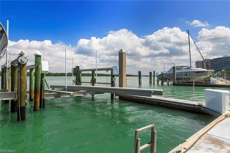 Dock area with a water view and boat lift