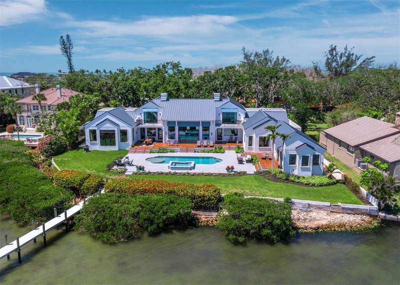 Elegant front entry through a gated motor court graced by Live Oak trees to the impressive residence .