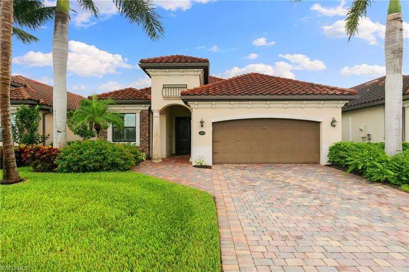 Mediterranean / spanish house featuring stucco siding, a front lawn, decorative driveway, and an attached garage