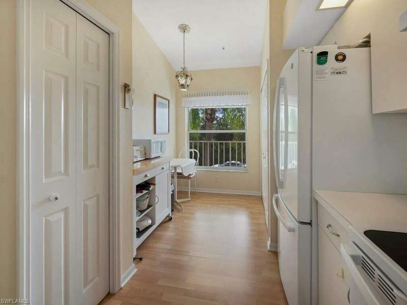 Living room with ceiling fan, vaulted ceiling, and wood-type flooring