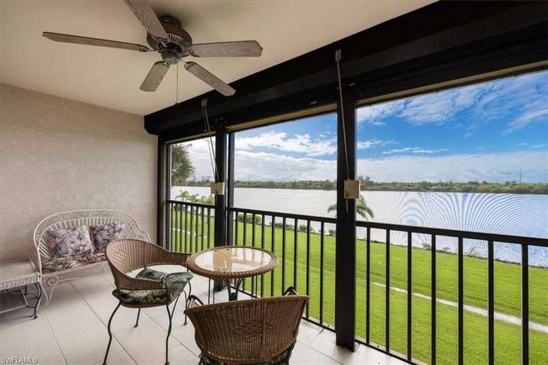Sunroom featuring a water view