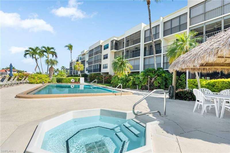 View of pool featuring a hot tub and a patio