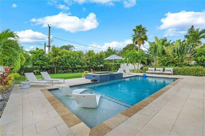 View of pool with an in ground hot tub and a patio area