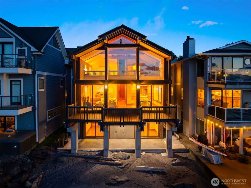 Rare waterfront gem on Alki shoreline. Features include heated floors, an elevator, indoor lap pool, jetted tub, spacious master walk-in closet, three gas fireplaces, metal roof, copper accents throughout, exposed beams, cherry wood floors.