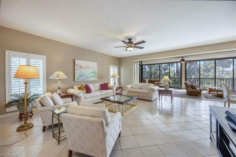 Tiled living room featuring ceiling fan