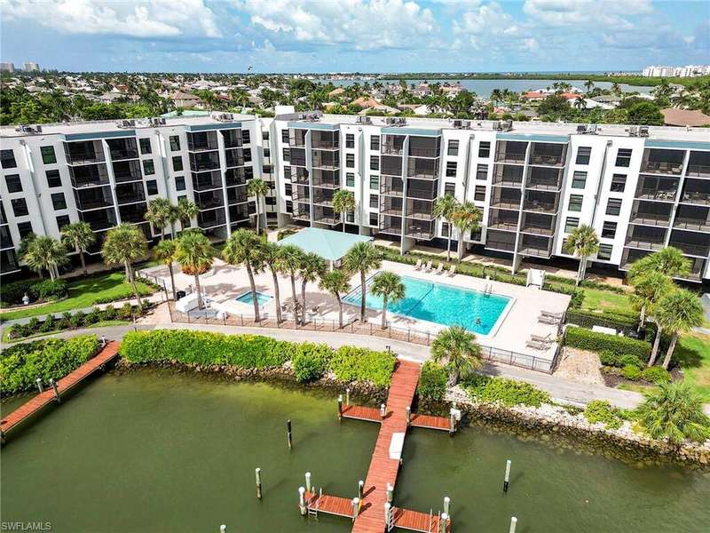 Aerial view of a nearby body of water and a pool area