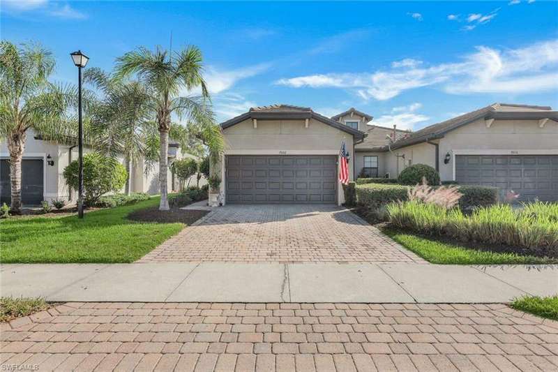 View of front of property featuring a front yard and a garage