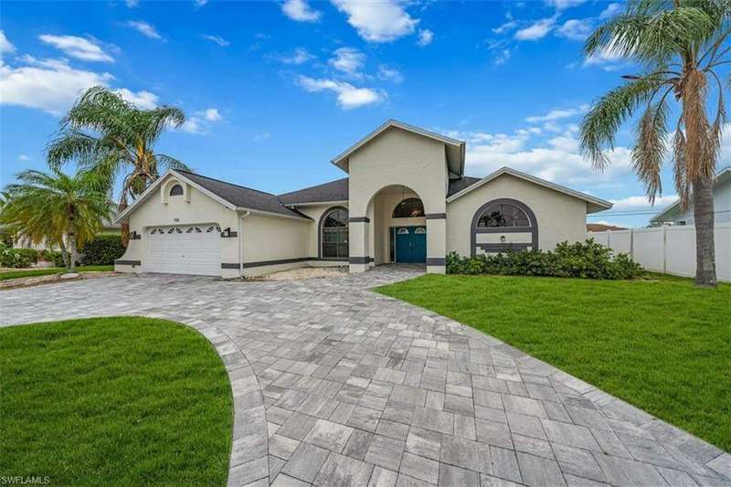 View of front of property with a garage and a front lawn. (Lawn has been enhanced).