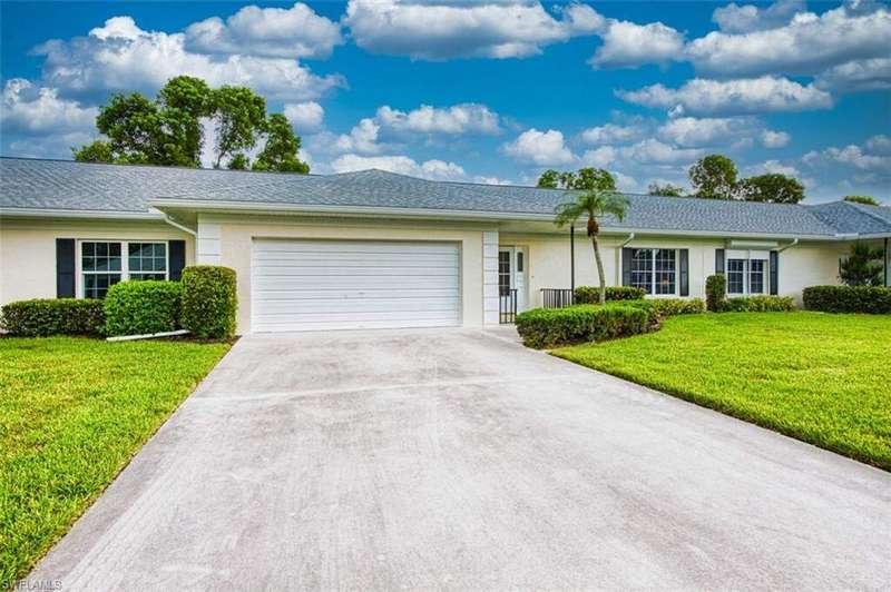 Ranch-style house with stucco siding, a front lawn, concrete driveway, and an attached garage