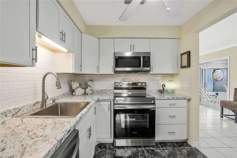Kitchen featuring sink, stainless steel appliances, and white cabinets