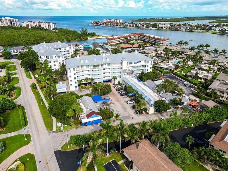 Aerial view of a large body of water and apartment complex / building