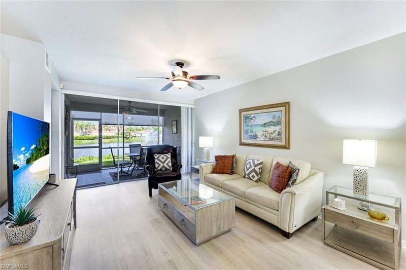 Living area with a ceiling fan and light wood-style floors