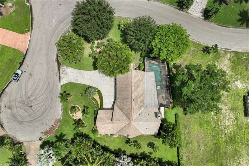 Single story home with a garage and a front yard