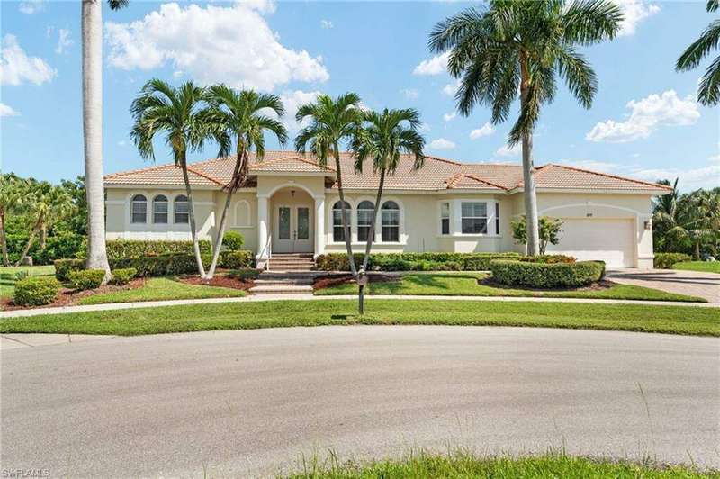 Mediterranean / spanish-style house with a front yard and a garage