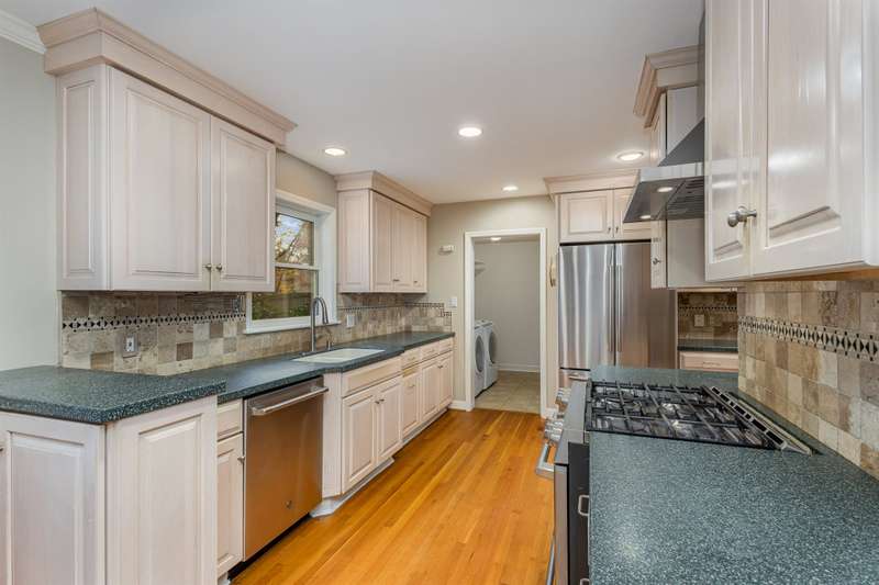 Kitchen area.  Gas stove.  A peek into the laundry room.