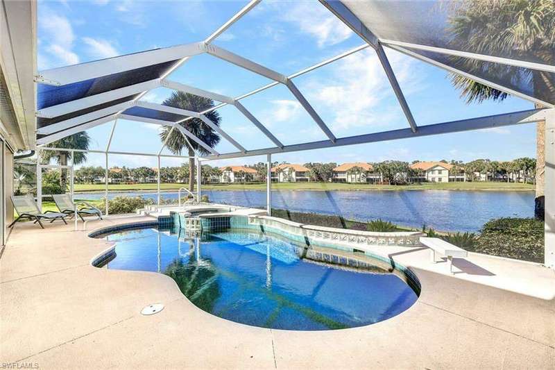 View of swimming pool with an in ground hot tub, a patio, a water view, and a lanai