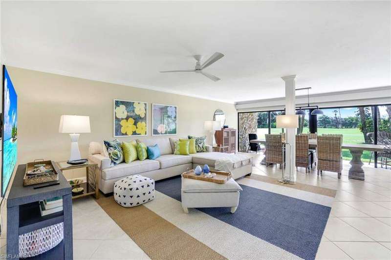 Living and Dining rooms looking out to private Lanai and the 12th Fairway.