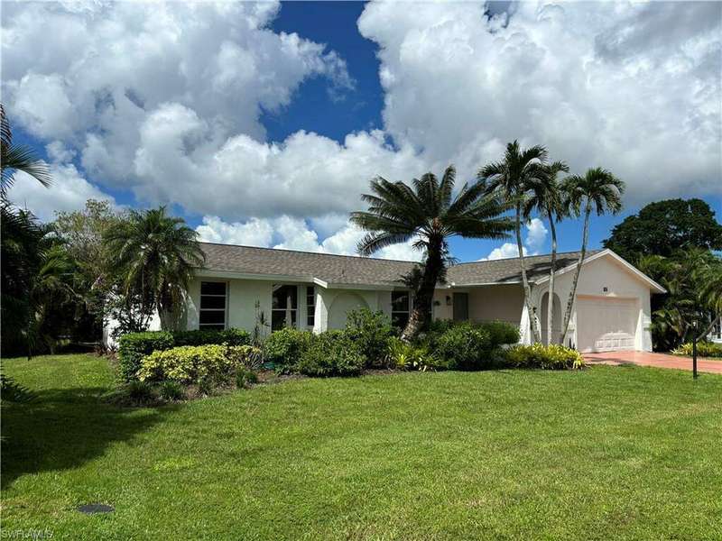 Ranch-style home featuring a garage and a front yard