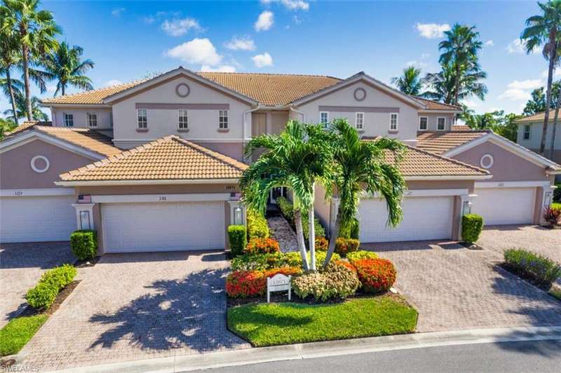 Mediterranean / spanish-style house featuring stucco siding, a tiled roof, and driveway