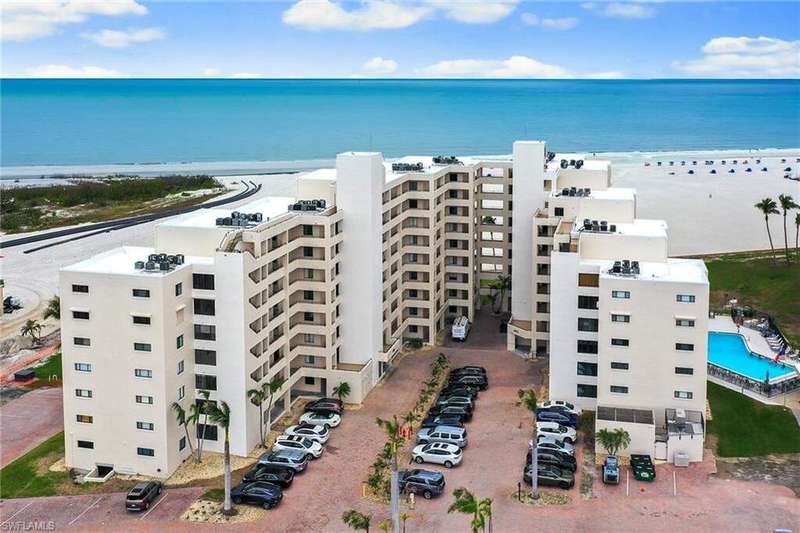 Bird's eye view of apartment complex / building and expansive coastline