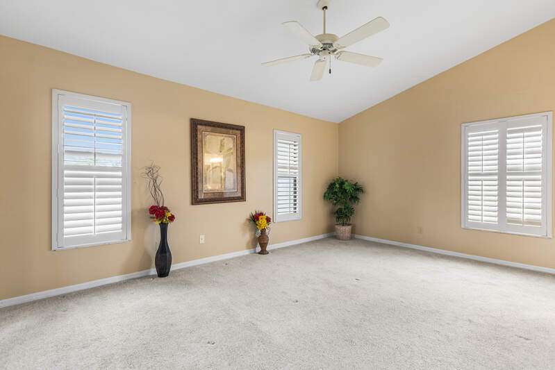 Mediterranean / spanish-style home with a front lawn, a tiled roof, concrete driveway, stucco siding, and an attached garage