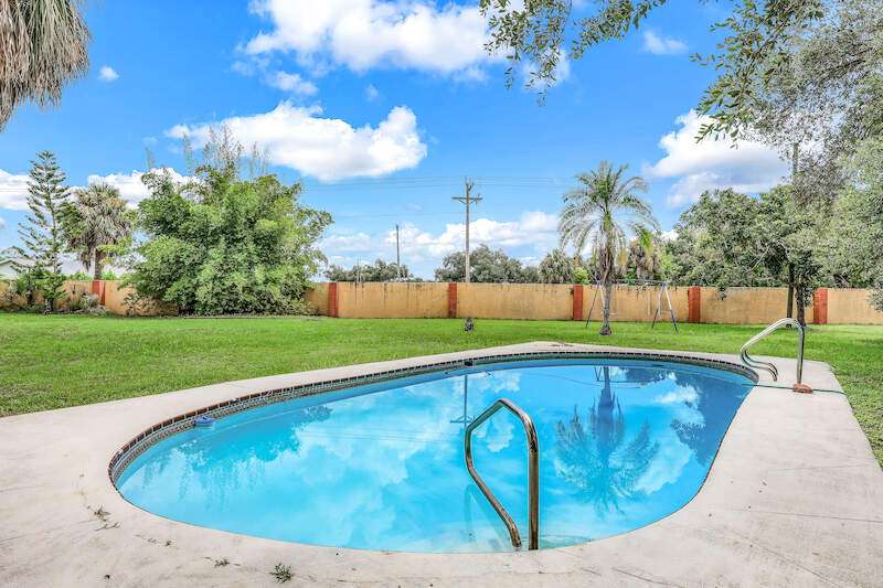 View of swimming pool with a lawn and a patio area