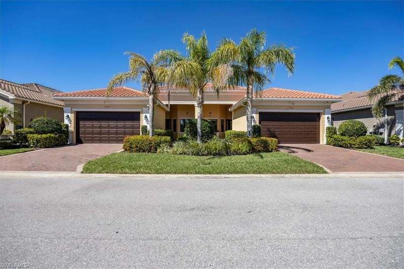 View of front of home featuring a tiled roof, decorative driveway, a garage, and stucco siding