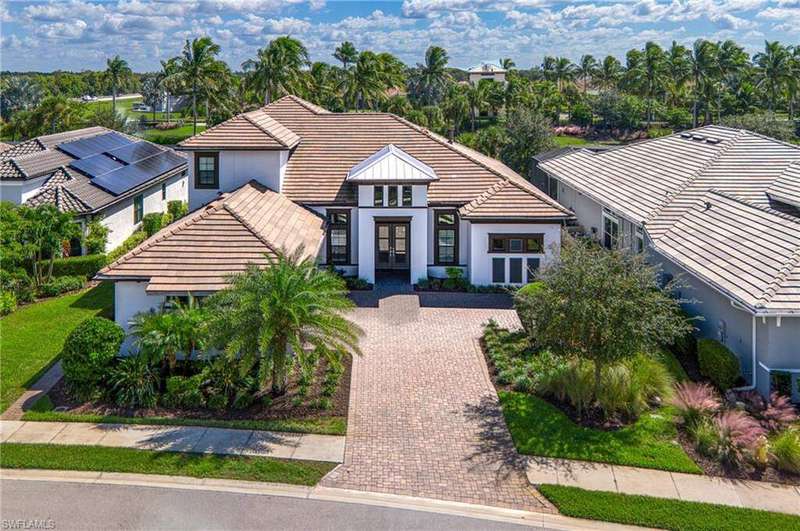 View of front of house with french doors, a tile roof, and stucco siding