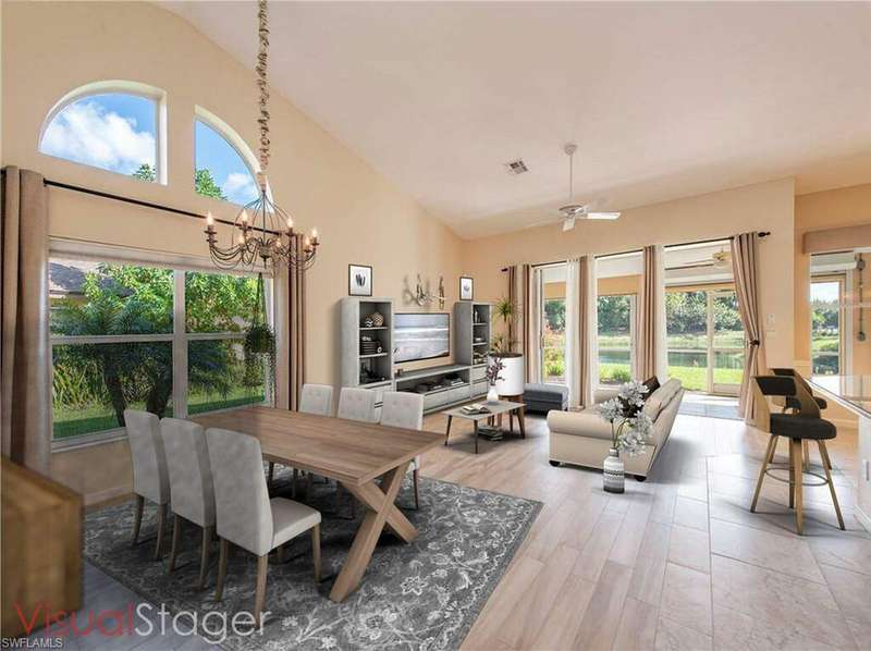 Dining area featuring high vaulted ceiling, light wood-type flooring, and plenty of natural light