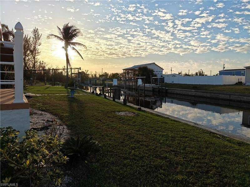 View of yard at dusk and boat lift