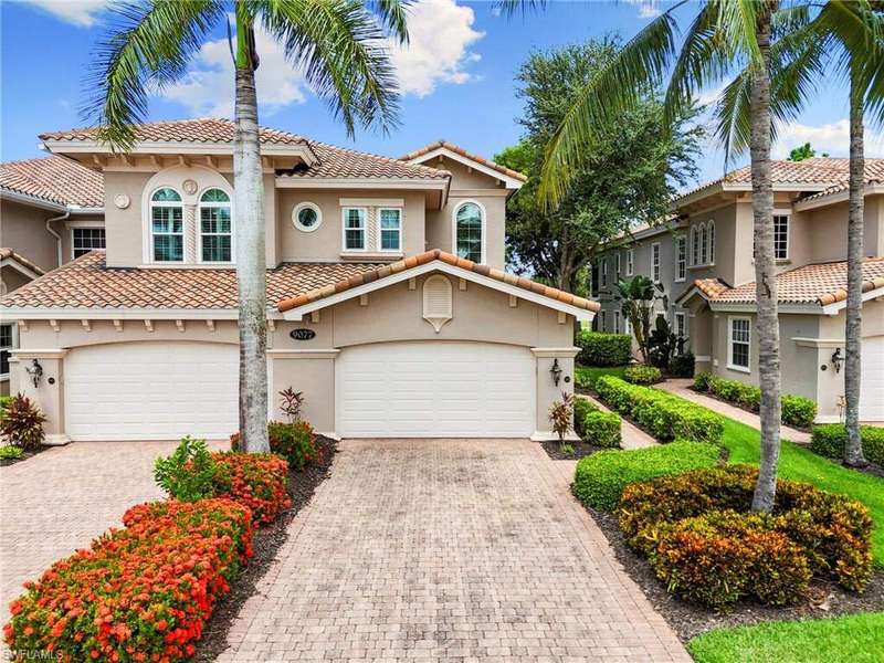 Mediterranean / spanish-style home with stucco siding, driveway, a tile roof, and an attached garage