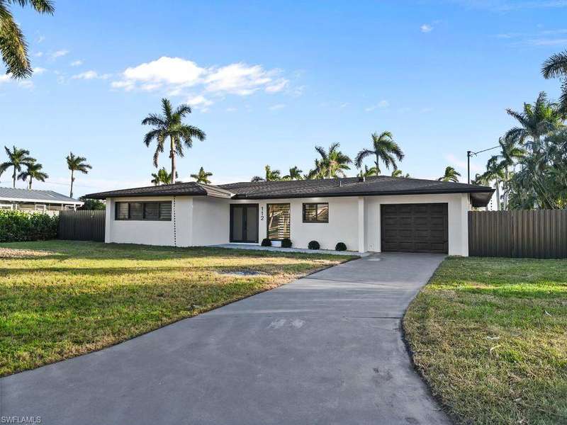 Single story home with stucco siding, a garage, and concrete driveway