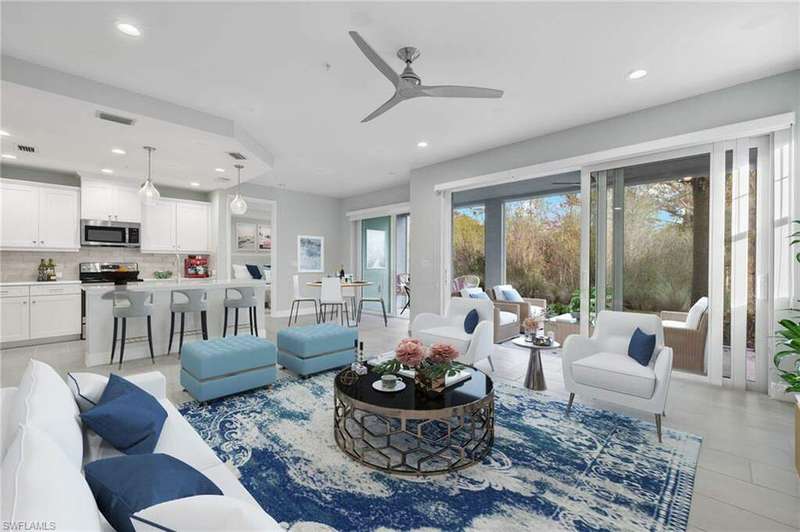 Living room with ceiling fan and light hardwood / wood-style floors