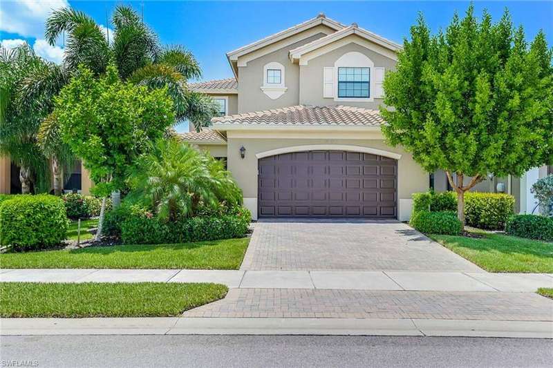 Mediterranean / spanish-style house with decorative driveway, stucco siding, a garage, and a tiled roof