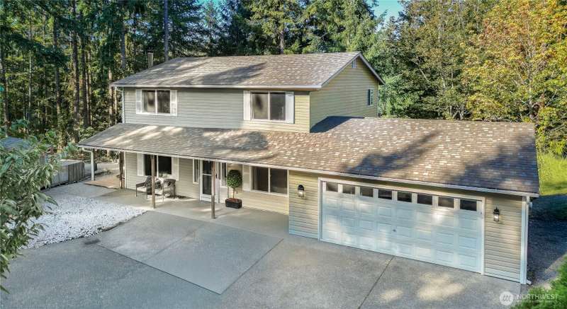 Drone view of front of home, love the large covered front porch!