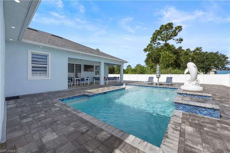 View of swimming pool with a patio area and a fenced backyard