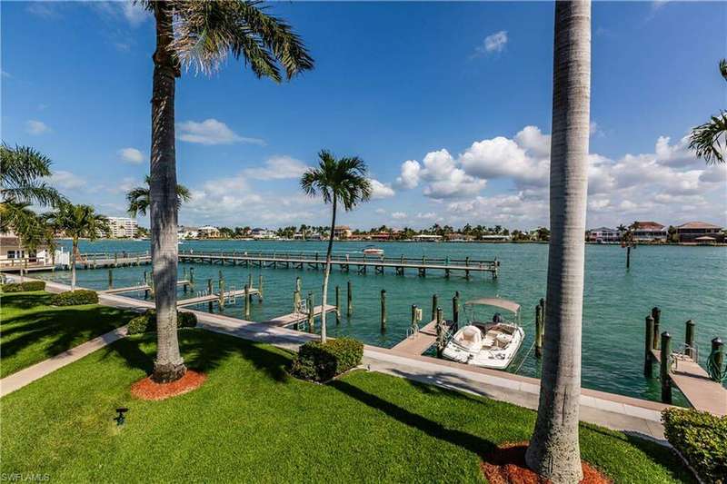 View of dock featuring a water view and a lawn