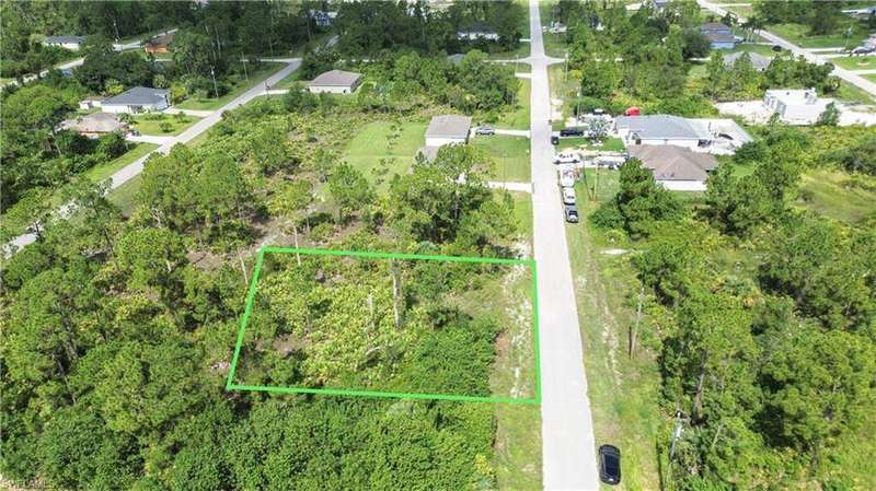 Aerial view of residential area with property parcel outlined