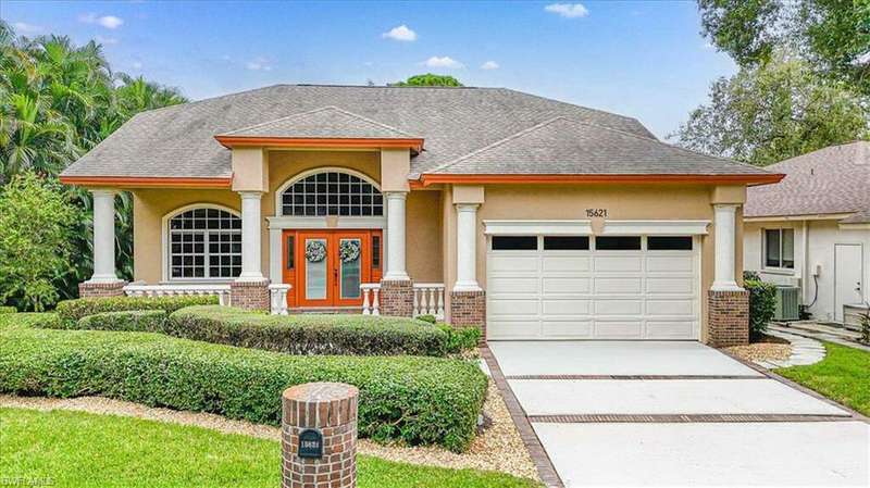 View of front of property with a garage and central air condition unit