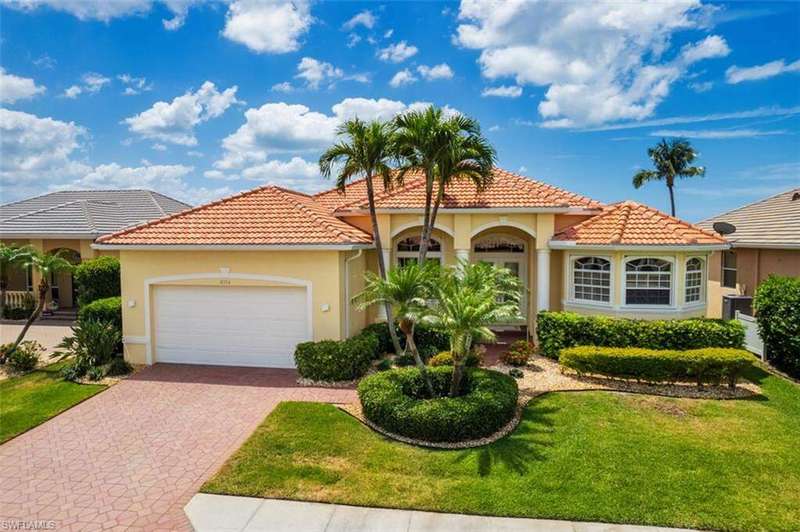 Mediterranean / spanish home with a garage, stucco siding, a front yard, decorative driveway, and a tiled roof