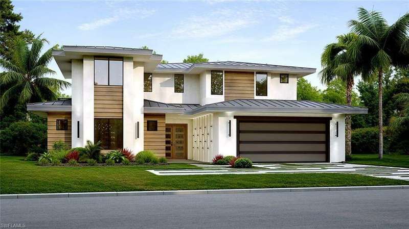 View of front of home with a garage and a front lawn