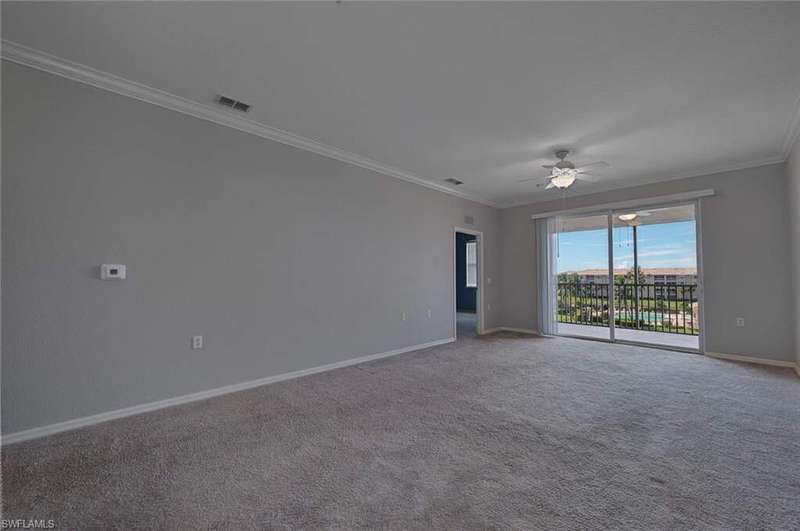Unfurnished room featuring ornamental molding, carpet, and a ceiling fan