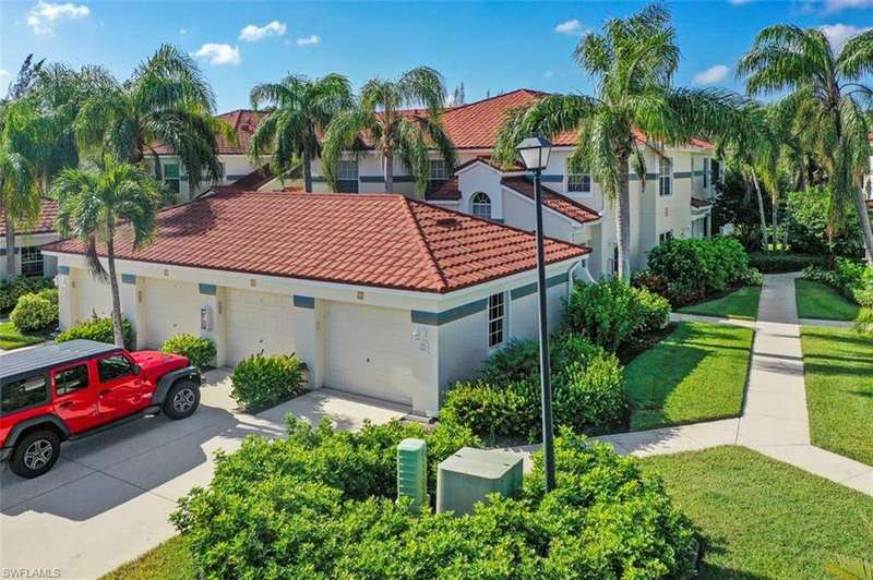 Mediterranean / spanish house featuring a garage and a front lawn