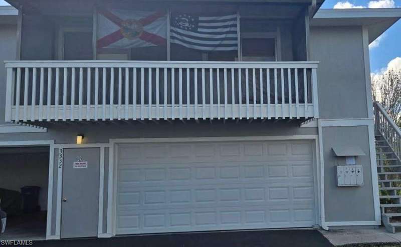 View of home's exterior featuring a garage and a balcony