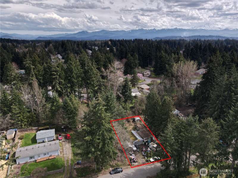 Bonney Lake, WA Rhododendron Park Lot is 8,625 SQ FT. Clean up needed. 1970 garage 600 SQ Ft. single wide mobile home 1963 needs to be removed, also shed on property.