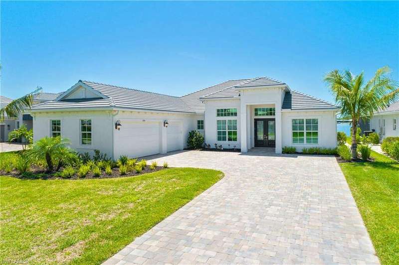 View of front facade featuring french doors, a garage, and a front yard