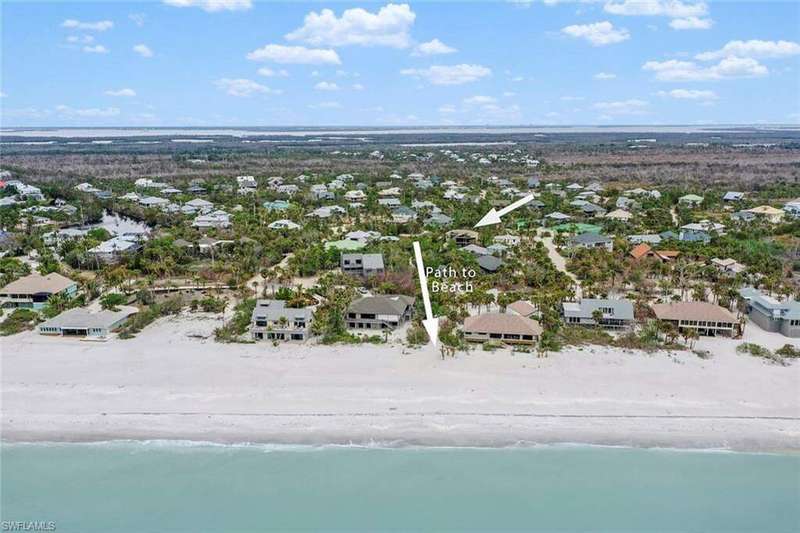Aerial view of property and private beach