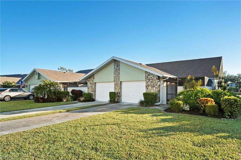 Ranch-style home with a garage and a front lawn