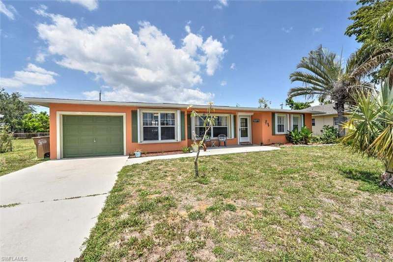 Single story home with an attached garage, concrete driveway, stucco siding, and a front lawn