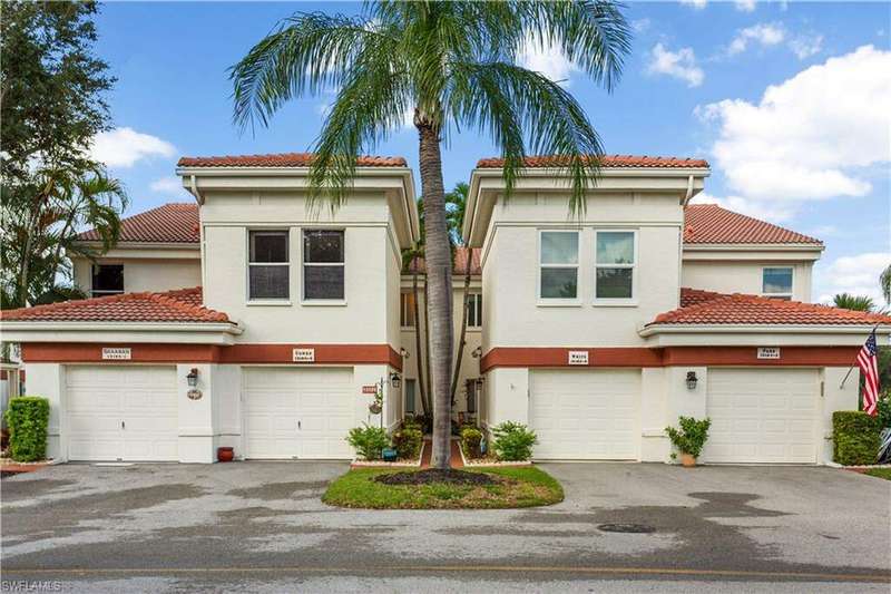 View of front of condo featuring a garage